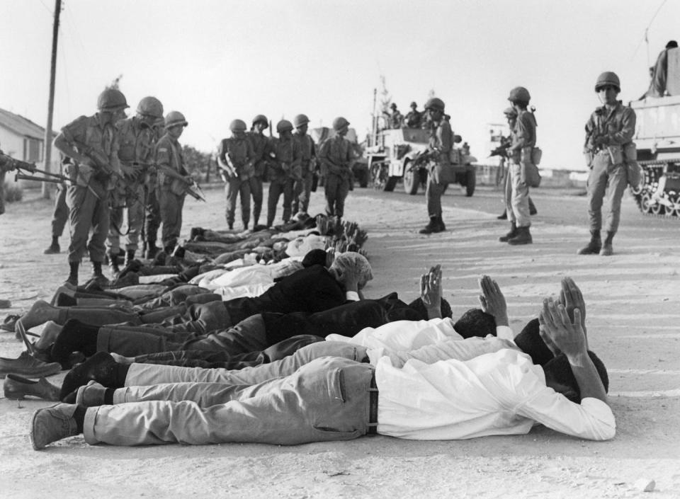 Palestinians surrender to Israeli soldiers in June 1967 in the occupied territory of the West Bank, during what is known as the Six-Day War. <a href="https://www.gettyimages.com/detail/news-photo/palestinians-surrender-to-israeli-soldiers-in-june-1967-in-news-photo/51347132?adppopup=true" rel="nofollow noopener" target="_blank" data-ylk="slk:Pierre Guillaud/AFP via Getty Images;elm:context_link;itc:0;sec:content-canvas" class="link ">Pierre Guillaud/AFP via Getty Images</a>