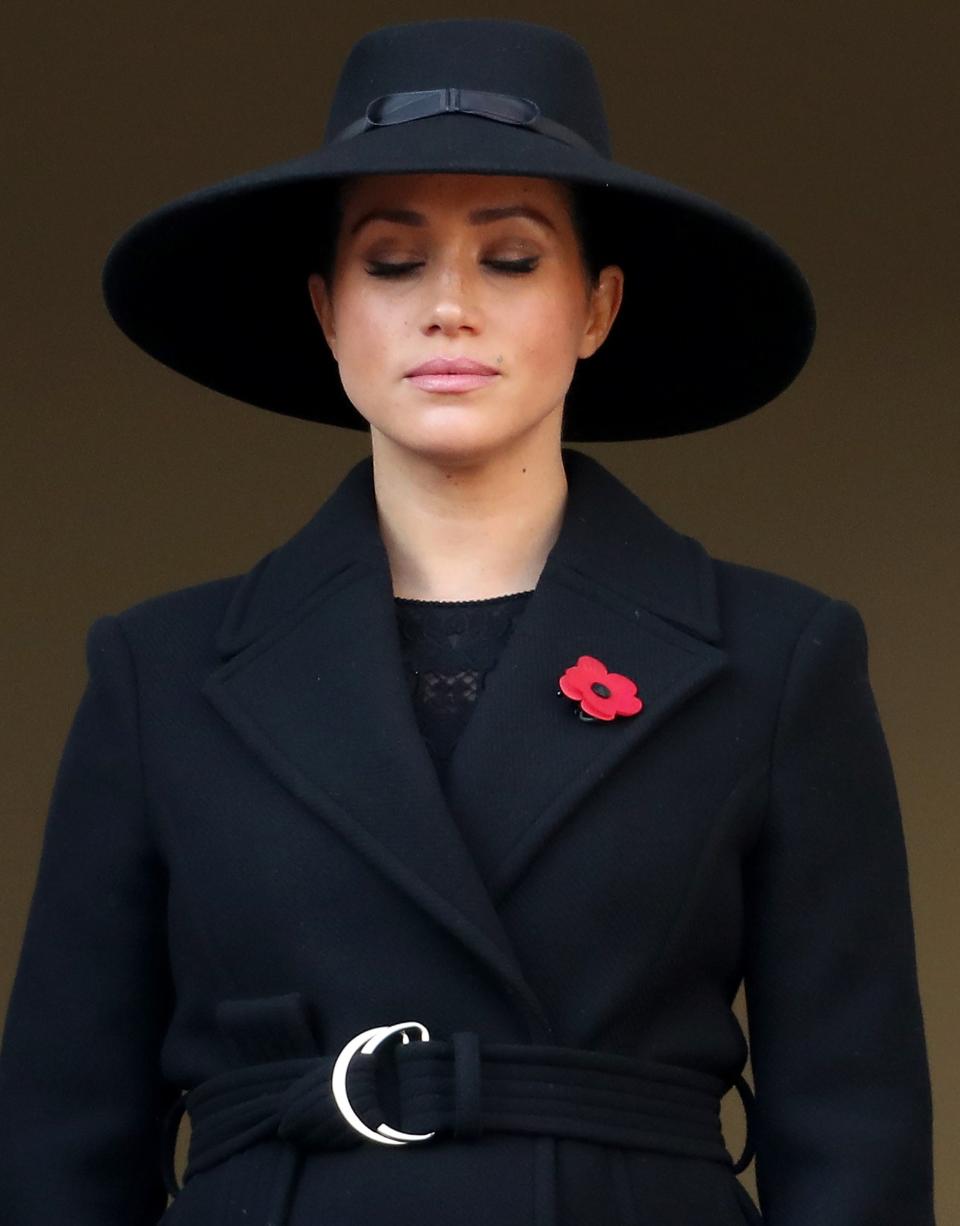 Meghan wore a belted black coat with a wide-brimmed hat while Kate sported a sleek black coat with military-style embellishments and a veiled hat. 