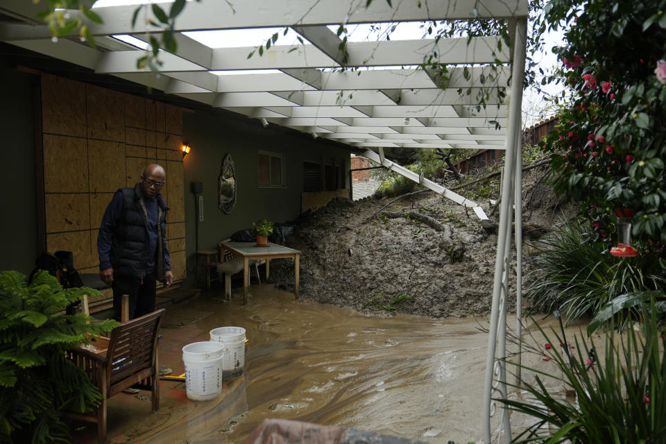Prentice Sinclair Smith a friend of home owner Dion Peronneau says she was awoken by the sound of cracking around 4 a.m. early morning Monday, as mudflow forced its way into her home in the Baldwin Hills area of Los Angeles, Tuesday, Feb. 6, 2024. One of the wettest storms in Southern California history unleashed more than 300 mudslides in the Los Angeles area after dumping more than half of the city's seasonal rainfall in just two days, and officials warned Tuesday that the threat hadn't passed yet. (AP Photo/Damian Dovarganes)