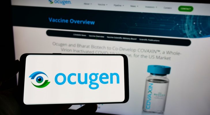 Person holding smartphone with logo of US biopharmaceutical company Ocugen Inc. (OCGN) on screen in front of website. Focus on phone display. Unmodified photo.