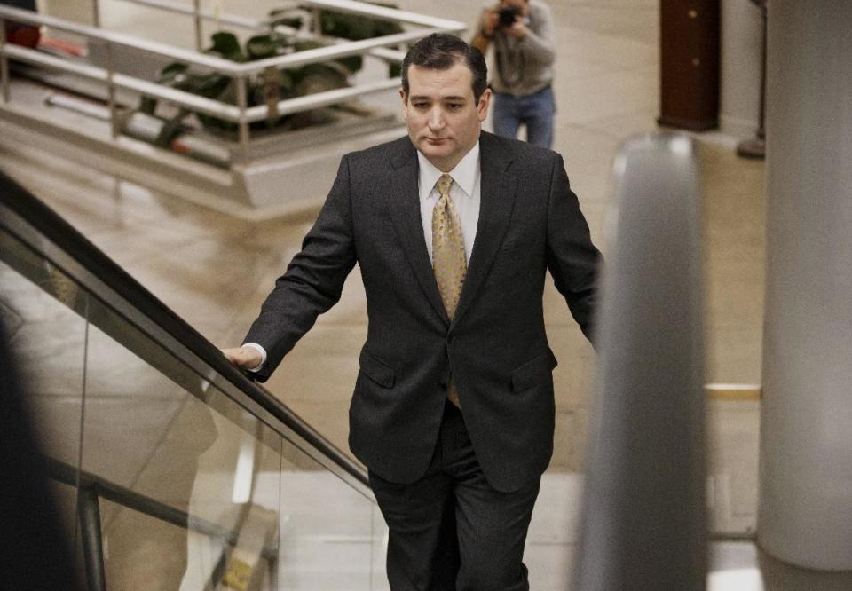 Sen. Ted Cruz, R-Texas arrives on Capitol Hill in Washington, Wednesday, Feb. 12, 2014, as senators go to the chamber for a vote to extend the Treasury's borrowing authority. Setting the vote in motion was one of Senate Republican leader Mitch McConnell’s Republican colleagues, Cruz, the tea party darling who has caused heartburn for his GOP colleagues in his year in the Senate. Cruz insisted on a 60-vote threshold for the Senate to proceed to legislation to allow the government to borrow money to pay its bills. (AP Photo/J. Scott Applewhite)