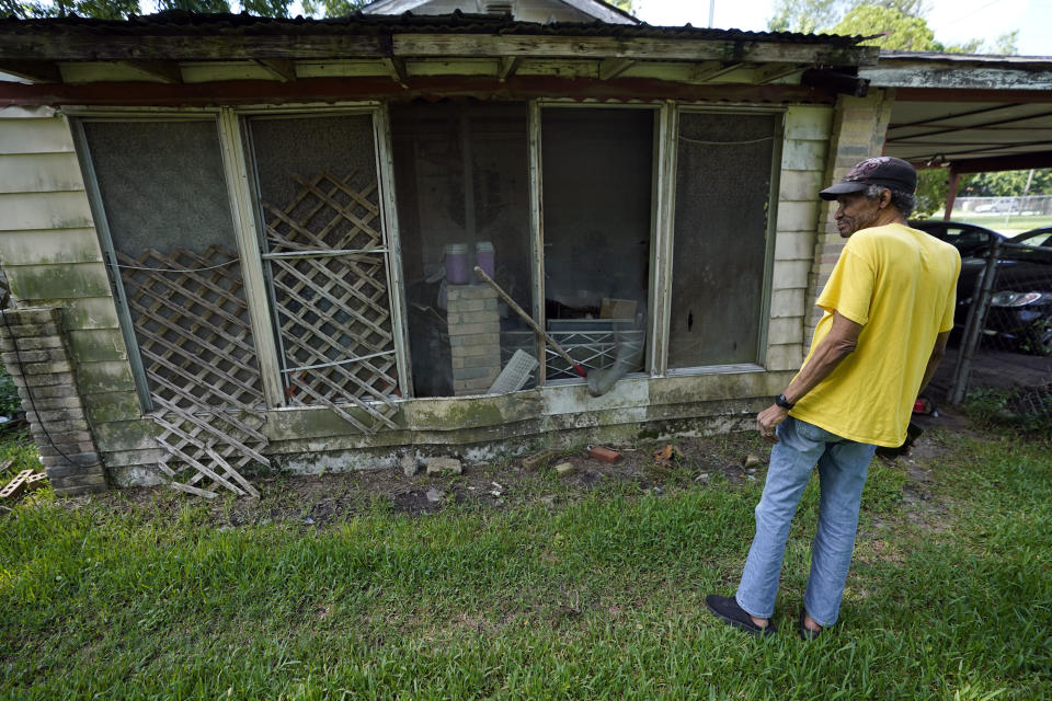 Mal Moses looks over some of the remaining damage to his home from Hurricane Harvey in 2017, Thursday, Aug. 25, 2022, in Houston. A local nonprofit, West Street Recovery, ultimately helped repair his home. (AP Photo/David J. Phillip)