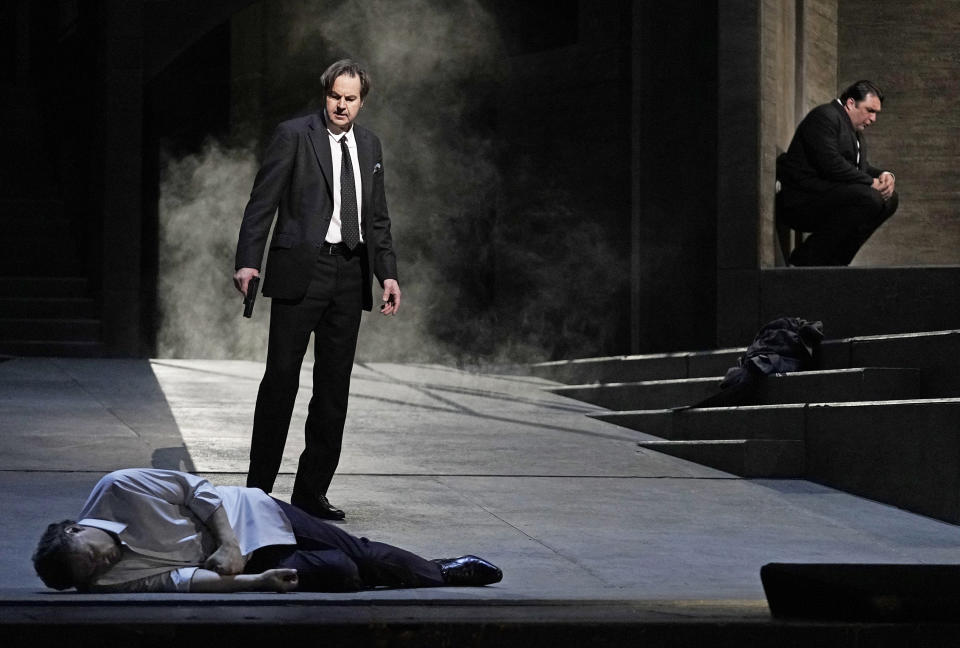 This image released by the Metropolitan Opera shows Alexander Tsymbalyuk, foreground, as the Commendatore, Peter Mattei as Don Giovanni, center, and Adam Plachetka as Leporello in Ivo van Hove's new production of Mozart's "Don Giovanni, opening at the Metropolitan Opera in New York on May 5. (Karen Almond/Met Opera via AP)