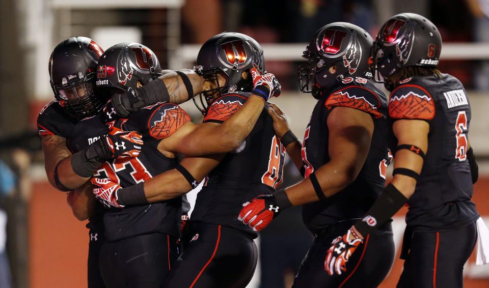 Utah’s Devontae Booker (23) celebrates a touchdown with teammates during game against USC on Saturday, Oct. 25, 2014, in Salt Lake City, Utah. Utah defeated USC 24-21. | Ravell Call, Deseret News