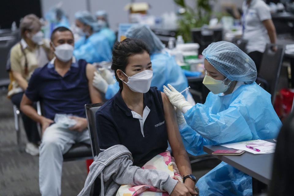 FILE - A health worker administers a dose of the AstraZeneca COVID-19 vaccine in Bangkok, Thailand on Nov. 17, 2021. Caseloads of omicron have remained relatively low in many countries in Asia. For now, many remain insulated from the worst, although the next few months will remain critical. (AP Photo/Sakchai Lalit, File)