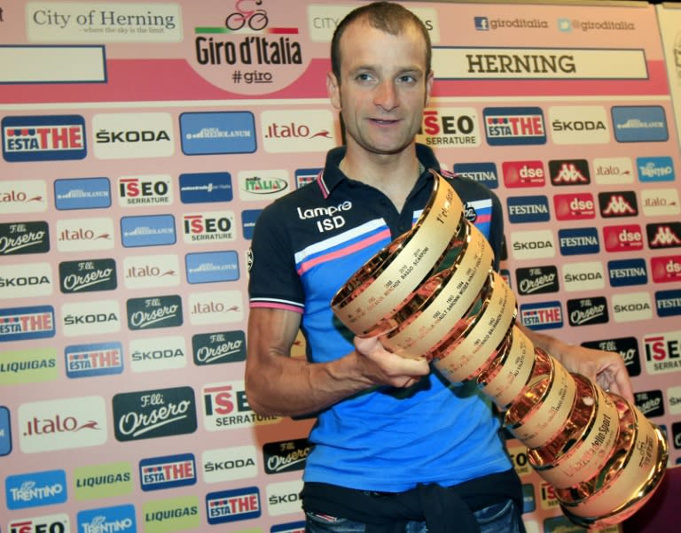 Italian cyclist Michele Scarponi posing with his 2011 Tour of Italy trophy