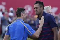 Team Europe's Rory McIlroy congratulates Team USA's Tony Finau after a four-ball match the Ryder Cup at the Whistling Straits Golf Course Friday, Sept. 24, 2021, in Sheboygan, Wis. (AP Photo/Jeff Roberson)