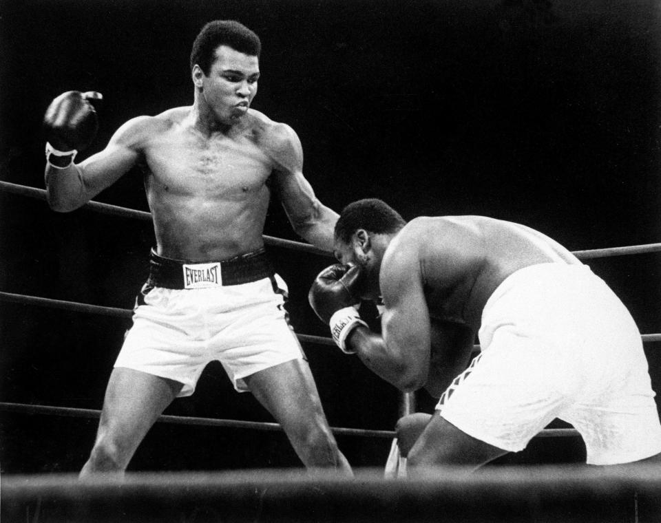 Muhammad Ali throws a punch at Joe Frazier, right, in the 12th round during their bout at Madison Square Garden on  Jan. 28, 1974.