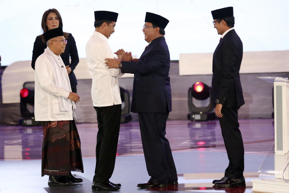 Indonesian President Joko Widodo, second left, and his running mate Ma'ruf Amin, left, and his contender Prabowo Subianto, second right, with his running mate Sandiaga Uno, right, shake hands after a televised debate in Jakarta, Indonesia, Thursday, Jan. 17, 2019. Indonesia is gearing up to hold its presidential election on April 17 that will pit in the incumbent against the former general.(AP Photo /Tatan Syuflana)