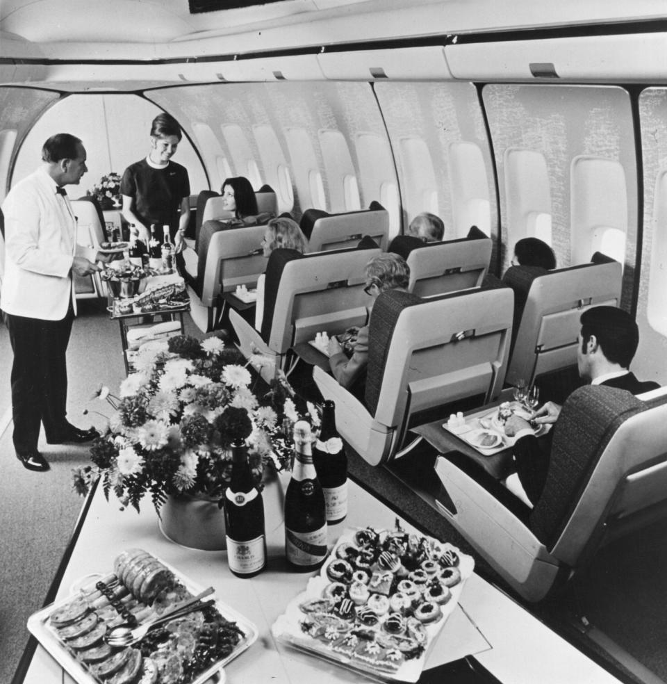 First-class passengers in a BOAC Boeing 747 Jumbo Jet are served lunch.