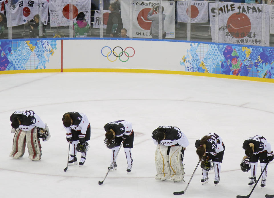 Members of Team Japan bow after their 4-0 loss to Germany in the 2014 Winter Olympics women's ice hockey game at Shayba Arena, Thursday, Feb. 13, 2014, in Sochi, Russia. (AP Photo/Matt Slocum)