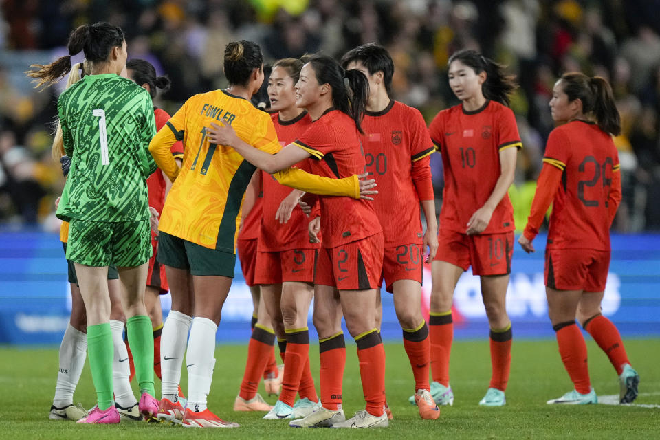 Australia's Mary Fowler is congratulated by Chinese players following the women's international soccer friendly between China and Australia at Stadium Australia, in Sydney, Monday, June 3, 2024. (AP Photo/Rick Rycroft)