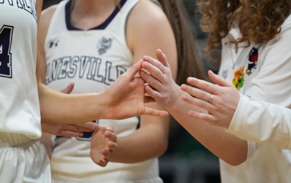 Lanesville Eagle Hadley Crosier (4) gets high fives as she leaves the game Saturday, Feb. 25, 2023, during IHSAA Class A state finals at Gainbridge Fieldhouse in Indianapolis. Lanesville defeated Bethany Christian, 60-41, for the title.