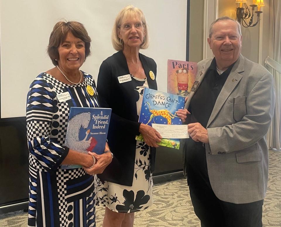 Friends of Lakewood Ranch Library member Sue Seiter, left, and organization president Sue Ann Miller receive a grant from Ladd Waldo, who chaired the Lakewood Ranch Rotary Club's grant committee.