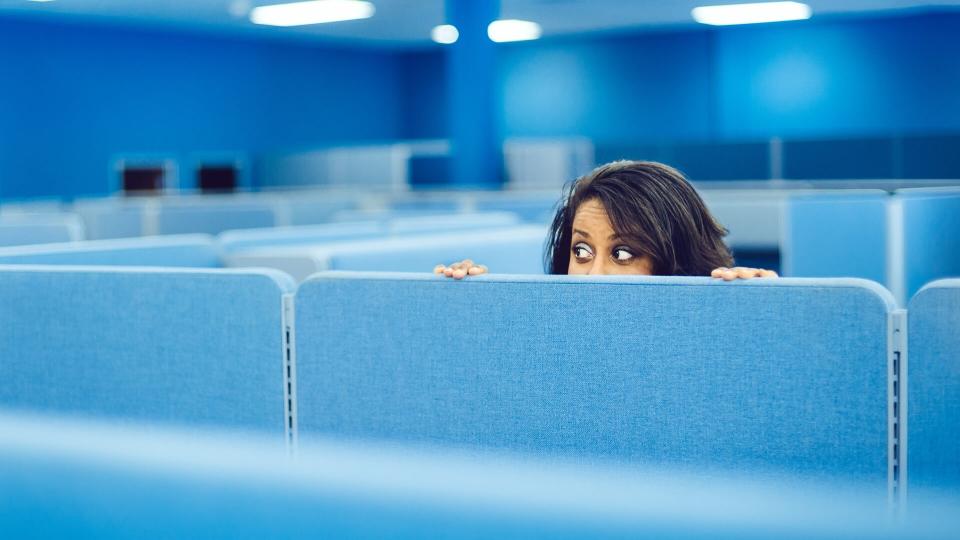 Office worker eavesdropping in cubicle room.