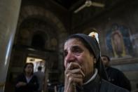 A nun is pictured after a bomb explosion at the Saint Peter and Saint Paul Coptic Orthodox Church in Cairo on December 11, 2016