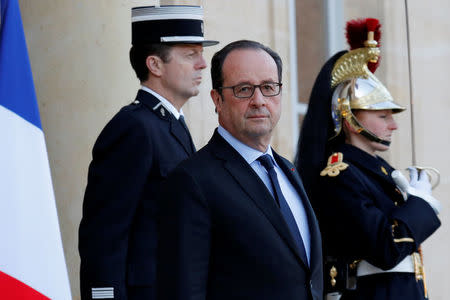 French President Francois Hollande waits for guests to leave the Elysee Palace in Paris, France, November 28, 2016. REUTERS/Philippe Wojazer