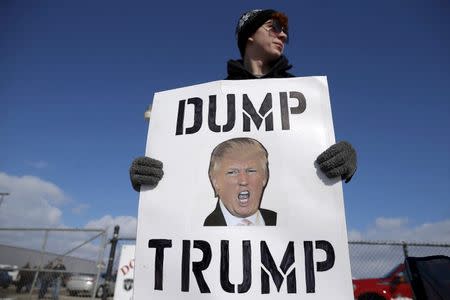 A protestor demonstrates outside a campaign rally for U.S. Republican presidential candidate Donald Trump in Cadillac, Michigan, March 4, 2016. REUTERS/Jim Young