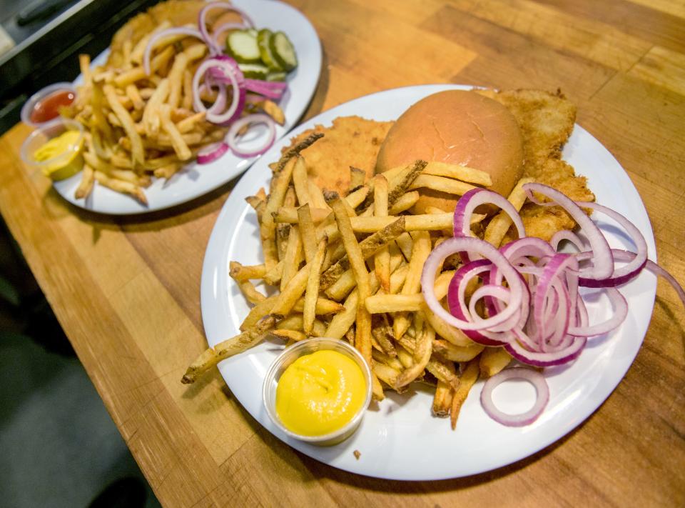 Two freshly-prepared orders of "Mama's Tenderloin" sit on a table in the kitchen at The BillBoard Bistro in Bartonville. The eatery recently revamped its menu to focus more on different varieties of tenderloins. The "Mama's Tenderloin" is a smaller version of the giant tenderloin.