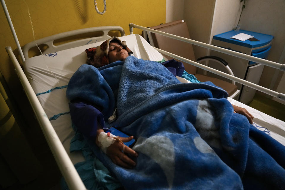 Mahdieh Sazmand who was wounded in Wednesday's bomb explosion lies on bed at Bahonar hospital in the city of Kerman about 510 miles (820 kms) southeast of the capital Tehran, Iran, Thursday, Jan. 4, 2024. Investigators believe suicide bombers likely carried out an attack on a commemoration for an Iranian general slain in a 2020 U.S. drone strike, state media reported Thursday, as Iran grappled with its worst mass-casualty attack in decades and as the wider Mideast remains on edge. (AP Photo/Vahid Salemi)