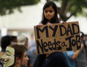 MIAMI, FL - OCTOBER 15: Anabella Campuzano sits on the shoulders of her father, Camilo Campuzano as she holds a sign that reads," My Dad Needs a Job"' as they particpate in an Occupy Miami protest on October 15, 2011 in Miami, Florida. Thousands of people are taking to the streets in cities across the world today in demonstrations inspired by the 'Occupy Wall Street' protests in New York City, an estimated 1,000 people showed up to participate in the Miami protest. (Photo by Joe Raedle/Getty Images)
