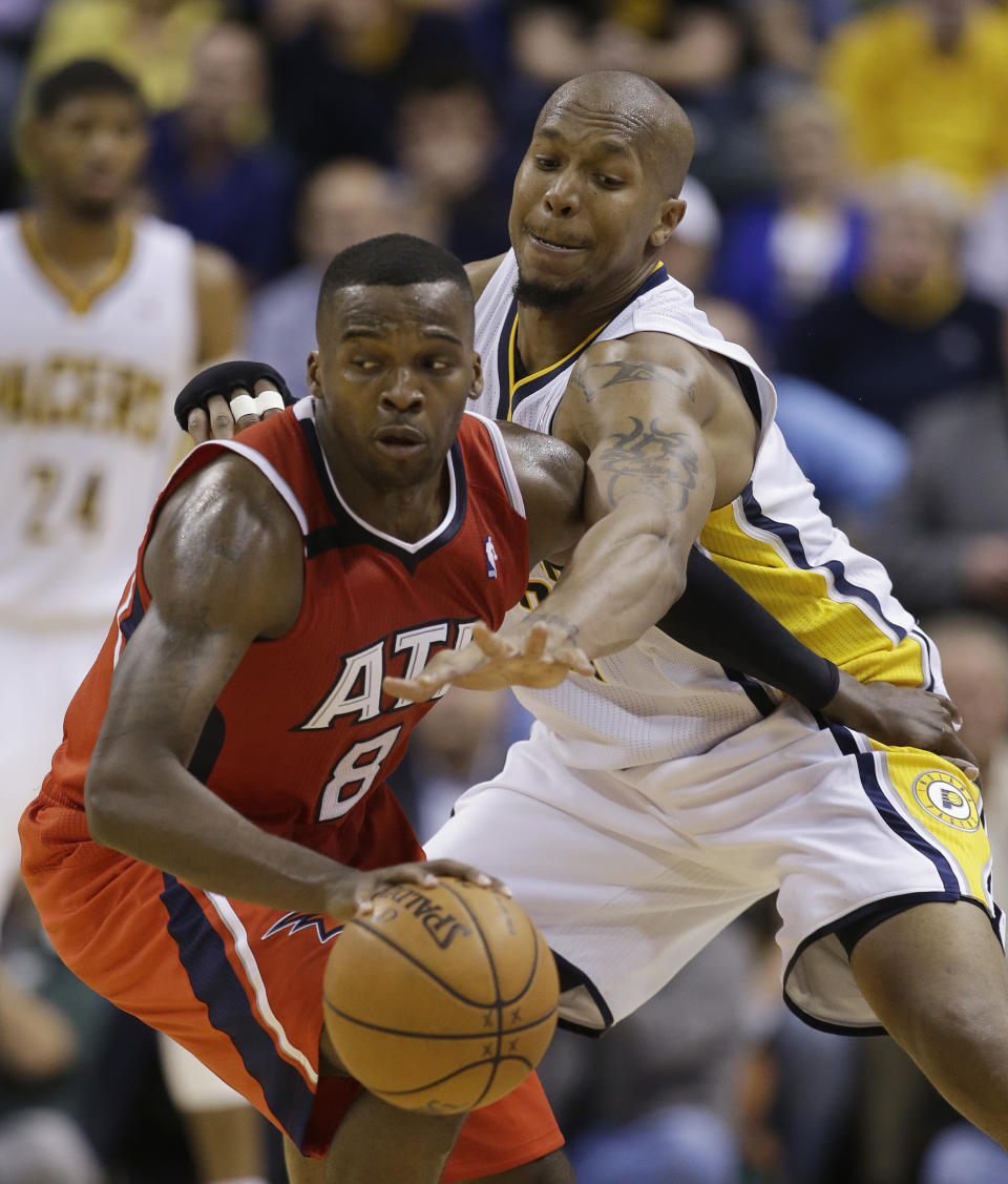 Atlanta Hawks' Shelvin Mack (8) is defended by Indiana Pacers' David West (21) during the second half in Game 5 of an opening-round NBA basketball playoff series Monday, April 28, 2014, in Indianapolis. Atlanta defeated Indiana 107-97. (AP Photo/Darron Cummings)