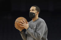 Golden State Warriors assistant coach and director of player development Jama Mahlalela watches as players practice before an NBA basketball game against the Detroit Pistons in San Francisco, Tuesday, Jan. 18, 2022. Coach Steve Kerr and his assistants met during the summer along with Stephen Curry and Draymond Green to review how they might practice more efficiently and with greater focus, and the resulting “Golden Hour” has meant so much to Golden State’s success so far.(AP Photo/Jed Jacobsohn)