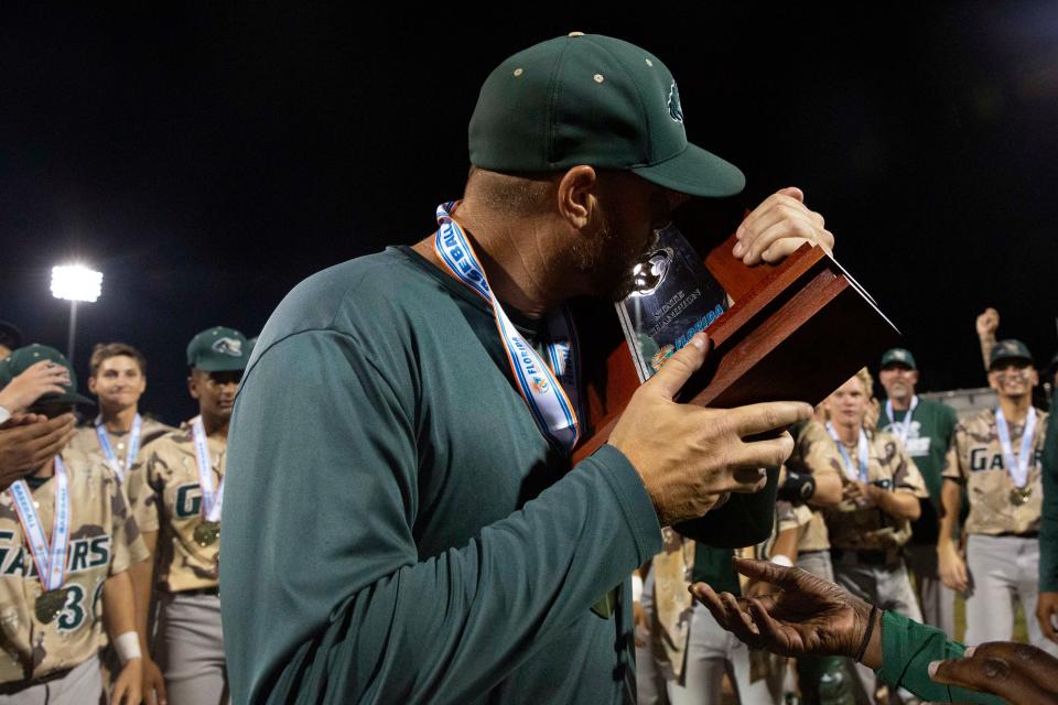 Island Coast's head coach Clint Montgomery celebrates after Island Coast defeated Jensen Beach 8-7 in eight innings to win the FHSAA baseball Class 4A state championship, Wednesday, May 25, 2022, at Hammond Stadium in Fort Myers, Fla.