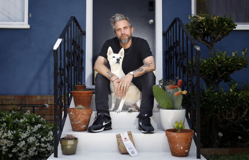 Richie Kulchar with an unwanted Uber Eats order and his dog Molly at home in Highland Park.