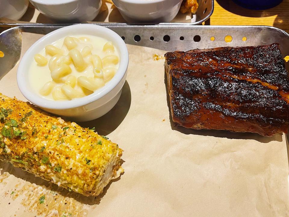 The baby back ribs with mac and cheese and street corn.