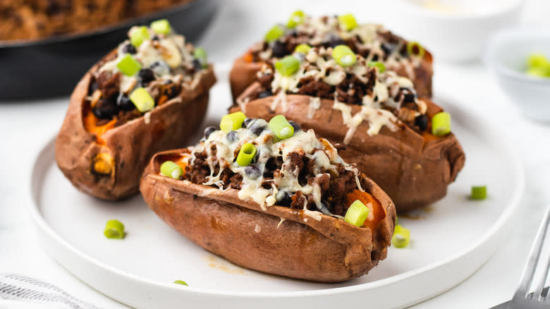 cheesy beef stuffed sweet potatoes on plate