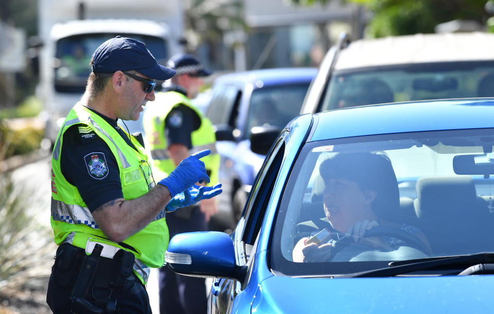 Police stop cars at a check point on the Queensland and New South Wales border in an attempt to stop Coronavirus. Source: AAP 