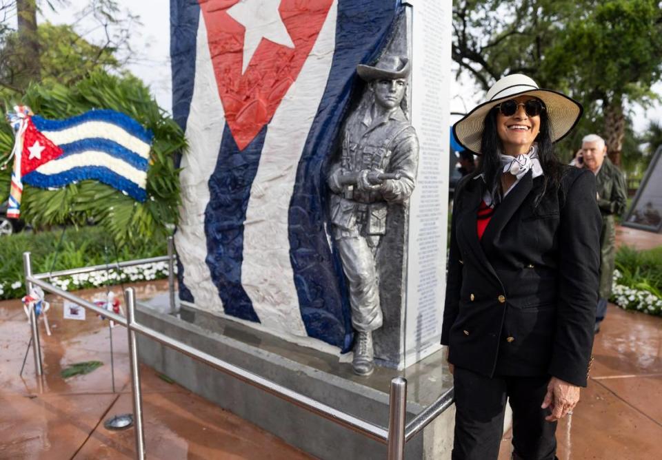 Nilda Comas stands next to a monument she sculpted at the Bay of Pigs Memorial Park on Wednesday, April 12, 2023, in Miami, Fla. District 4