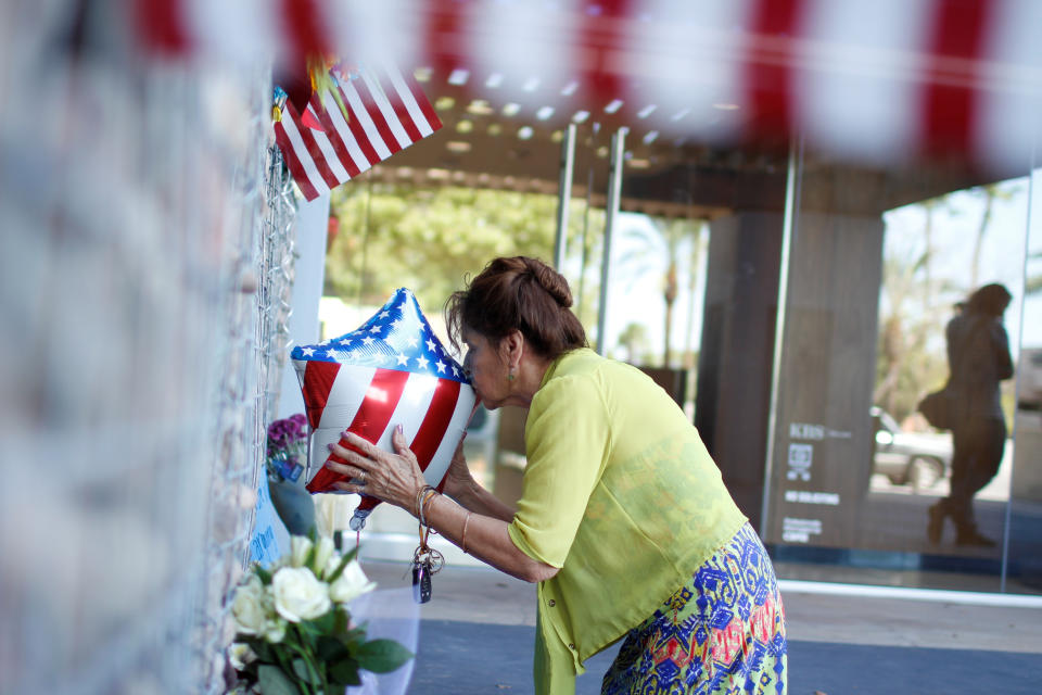 <p>Maria Vicllalpando kisses a balloon and leaves a rosary in front of a memorial for late Sen. John McCain, outside his office in Phoenix, Ariz., Aug. 26, 2018. (Photo: Nicole Neri/Reuters) </p>