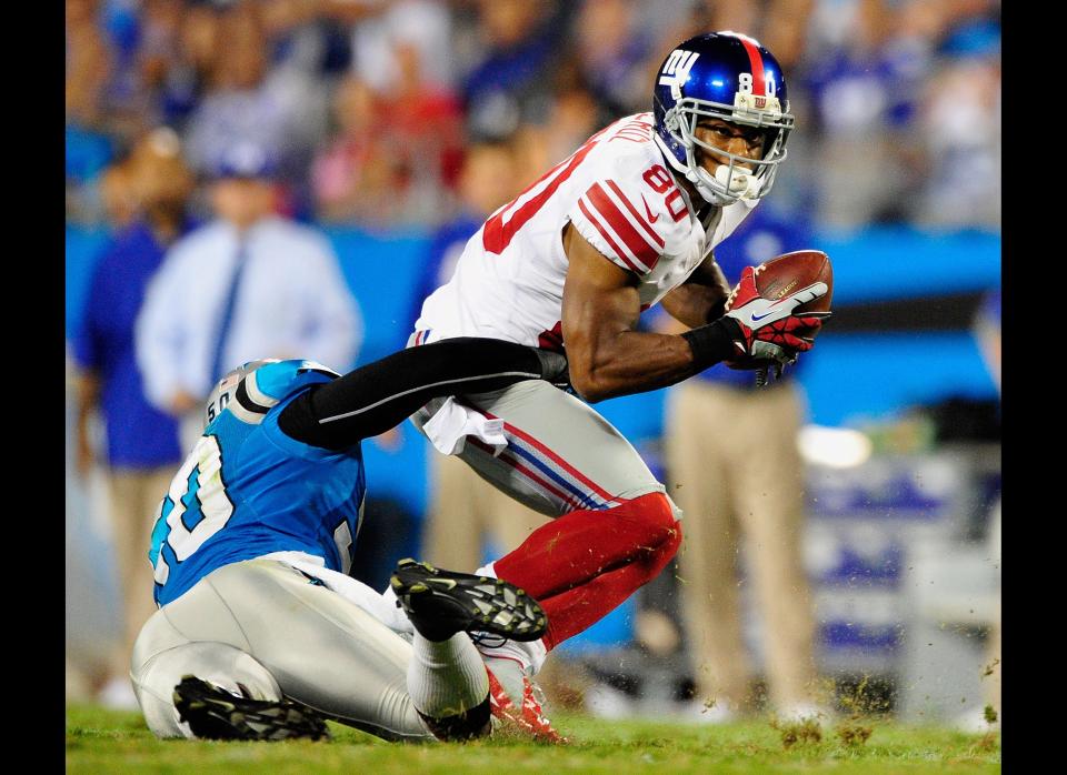 Victor Cruz #80 of the New York Giants makes a catch as Charles Godfrey #30 of the Carolina Panthers defends during play at Bank of America Stadium on September 20, 2012 in Charlotte, North Carolina.