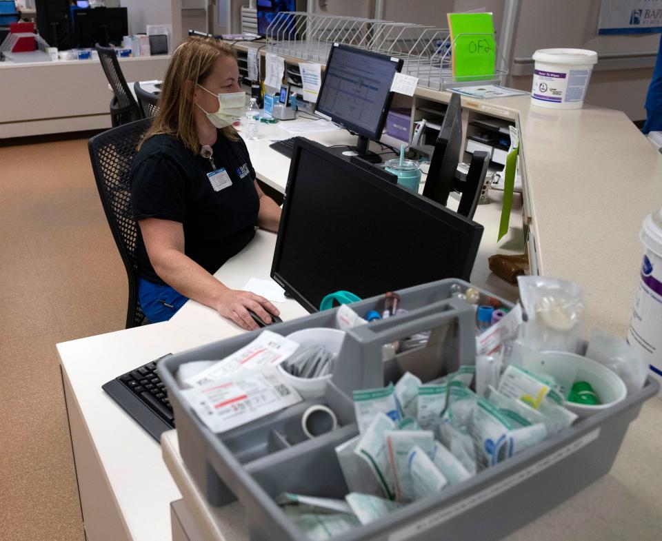 Registered nurse Melanie Bailey charts a patient's care information Tuesday at the emergency room at Baptist Health Care's Gulf Breeze Hospital. Employers like Baptist Health Care are becoming more competitive and innovative in their efforts to attract and retain employees in the current economy.