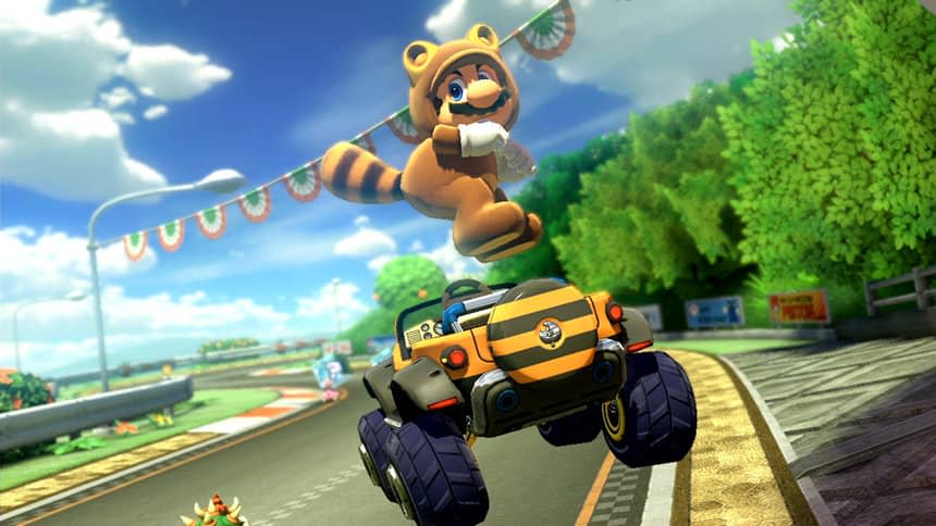 Mario, wearing a tanuki (raccoon-like) suit, jumps into the air and sticks his butt out above a striped off-roader.