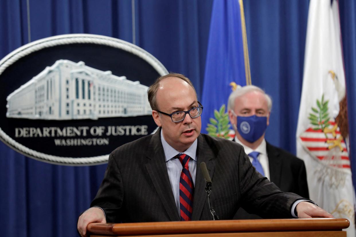 Acting Assistant Attorney General Jeffrey Clark speaks next to Deputy Attorney General Jeffrey Rosen at a news conference, where they announced that Purdue Pharma LP has agreed to plead guilty to criminal charges over the handling of its addictive prescription opioid OxyContin, at the Justice Department in Washington, on Oct. 21, 2020.