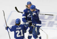 Tampa Bay Lightning defenseman Mikhail Sergachev (98) celebrates his goal against the Dallas Stars with teammates Erik Cernak (81) and Brayden Point (21) during the third period of Game 5 of the NHL hockey Stanley Cup Final, Saturday, Sept. 26, 2020, in Edmonton, Alberta. (Jason Franson/The Canadian Press via AP)