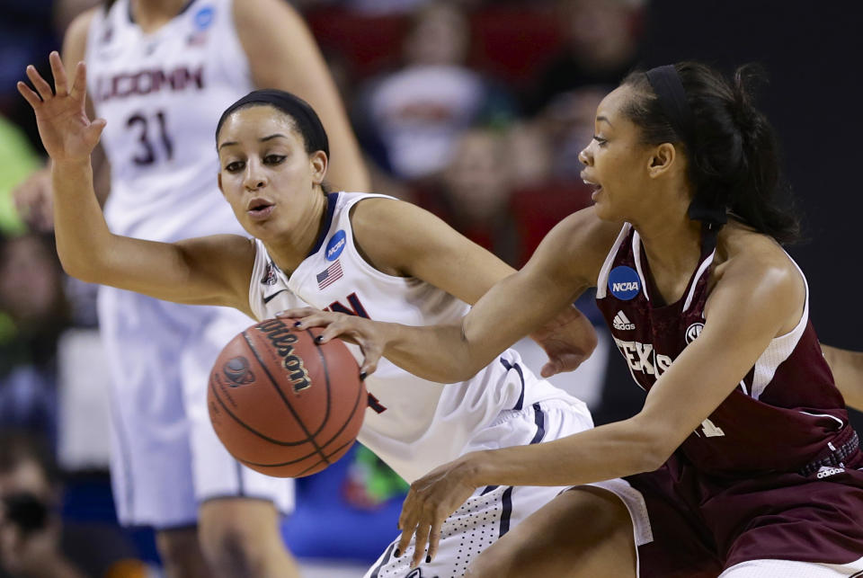 Texas A&M's Curtyce Knox, right, passes the ball past Connecticut's Bria Hartley, left, during the first half of a regional final game in the NCAA college basketball tournament in Lincoln, Neb., Monday, March 31, 2014. (AP Photo/Nati Harnik)