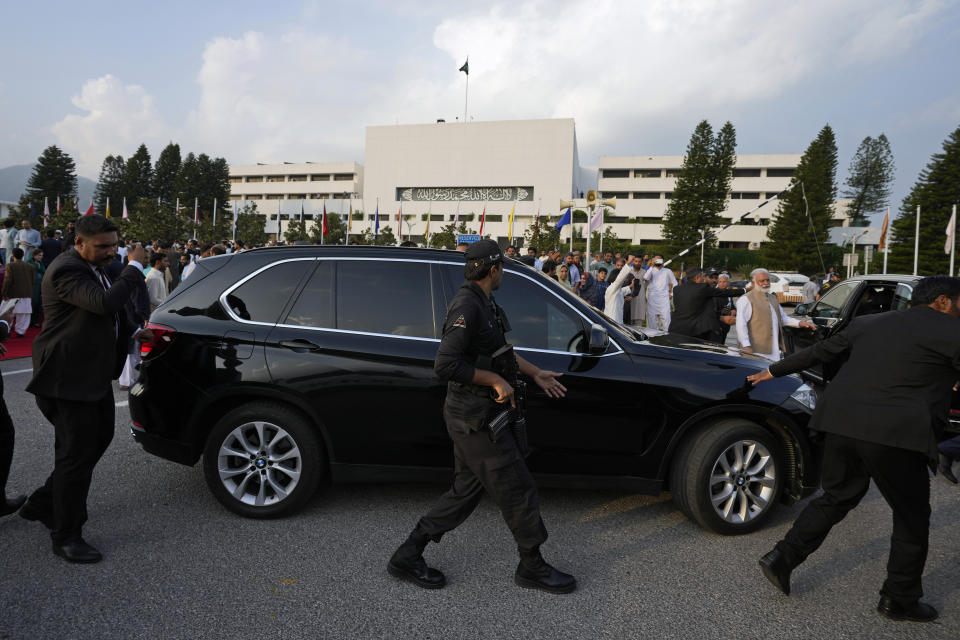 Security personnels secure the vehicle of Pakistan's Prime Minister Shehbaz Sharif as he leaves after a group photo with lawmakers of the National Assembly at the end of the last session of the current parliament, in Islamabad, Pakistan, Wednesday, Aug. 9, 2023. Pakistan's prime minister took a formal step Wednesday toward dissolving parliament, starting a possible countdown to a general election, as his chief political rival fought to overturn a corruption conviction that landed him in a high-security prison over the weekend. (AP Photo/Anjum Naveed)