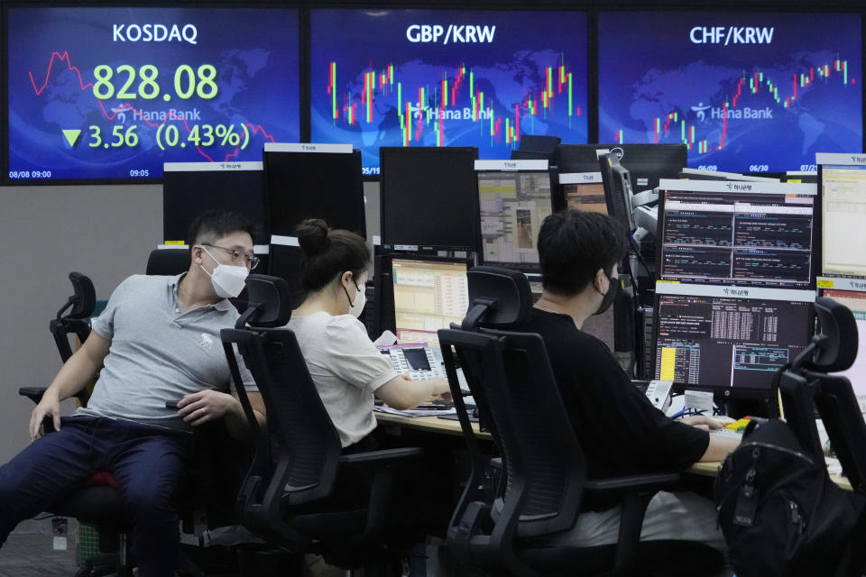 Currency traders work at the foreign exchange dealing room of the KEB Hana Bank headquarters in Seoul, South Korea, Monday, Aug. 8, 2022. Asian stocks were mixed Monday after strong U.S. jobs data cleared the way for more interest rate hikes and Chinese exports rose by double digits. (AP Photo/Ahn Young-joon)