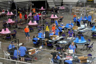 FILE - In this May 6, 2021 file photo, Maricopa County ballots cast in the 2020 general election are examined and recounted by contractors working for Florida-based company, Cyber Ninjas at Veterans Memorial Coliseum in Phoenix. Election officials and experts are raising alarms about the private fundraising surrounding efforts to expand Republican ballot reviews to more states former President Donald Trump falsely claims he won. While some fundraising details have come to light, information about who is donating the money and how it's being spent is largely exempt from public disclosure. (AP Photo/Matt York, Pool)