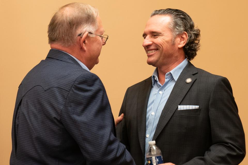 House Speaker Dan Hawkins, R-Wichita, shakes hands with Senate President Ty Masterson, R-Andover, before the start of Thursday's event at the Statehouse.