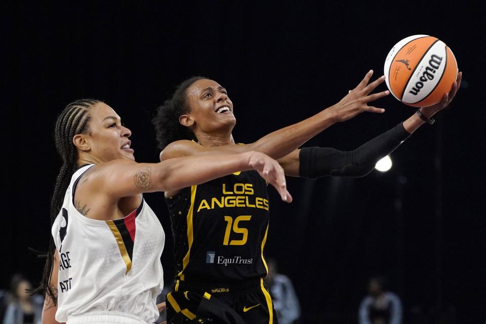 Los Angeles Sparks guard Brittney Sykes, right, shoots as Las Vegas Aces center Liz Cambage defends during the first half of a WNBA basketball game Friday, July 2, 2021, in Los Angeles. (AP Photo/Mark J. Terrill)