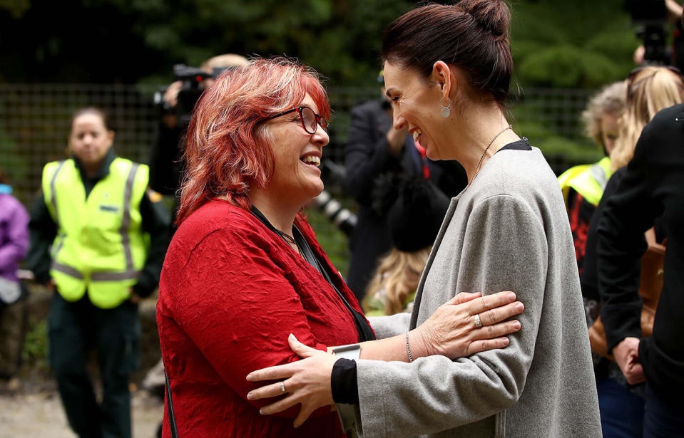 A diamond ring is seen on the middle finger of Jacinda Ardern's hand (right) as she embraces Anna Osborne from the Family Reference Group, at a ceremony at Pike River. Source: Phil Walter/Getty Images