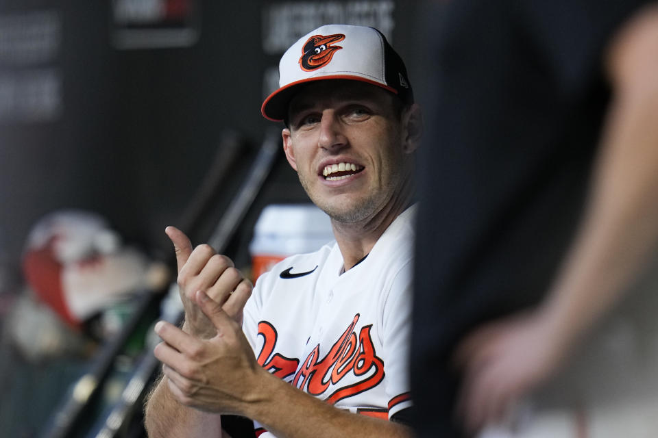 Baltimore Orioles starting pitcher John Means talks to teammates in the dugout in the first inning of a baseball game against the St. Louis Cardinals, Tuesday, Sept. 12, 2023 in Baltimore. (AP Photo/Julio Cortez)