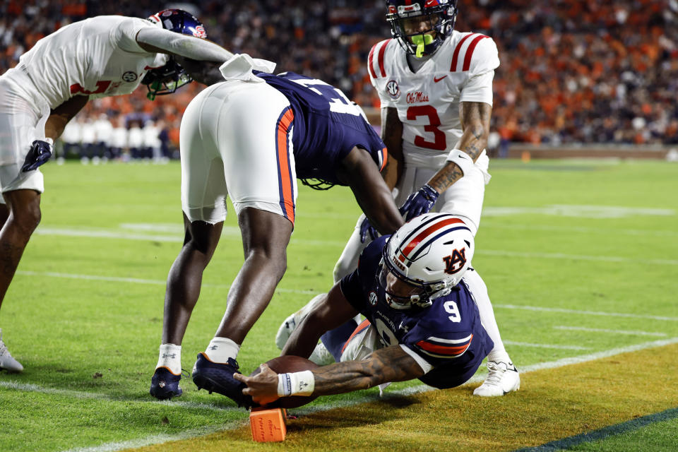 Auburn quarterback Robby Ashford (9) dives for the pylon but comes up short during the first half of an NCAA college football game against Mississippi, Saturday, Oct. 21, 2023, in Auburn, Ala. (AP Photo/ Butch Dill )
