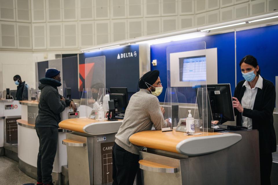 Delta employees assist customers at the George Bush Intercontinental Airport in Houston, Texas.