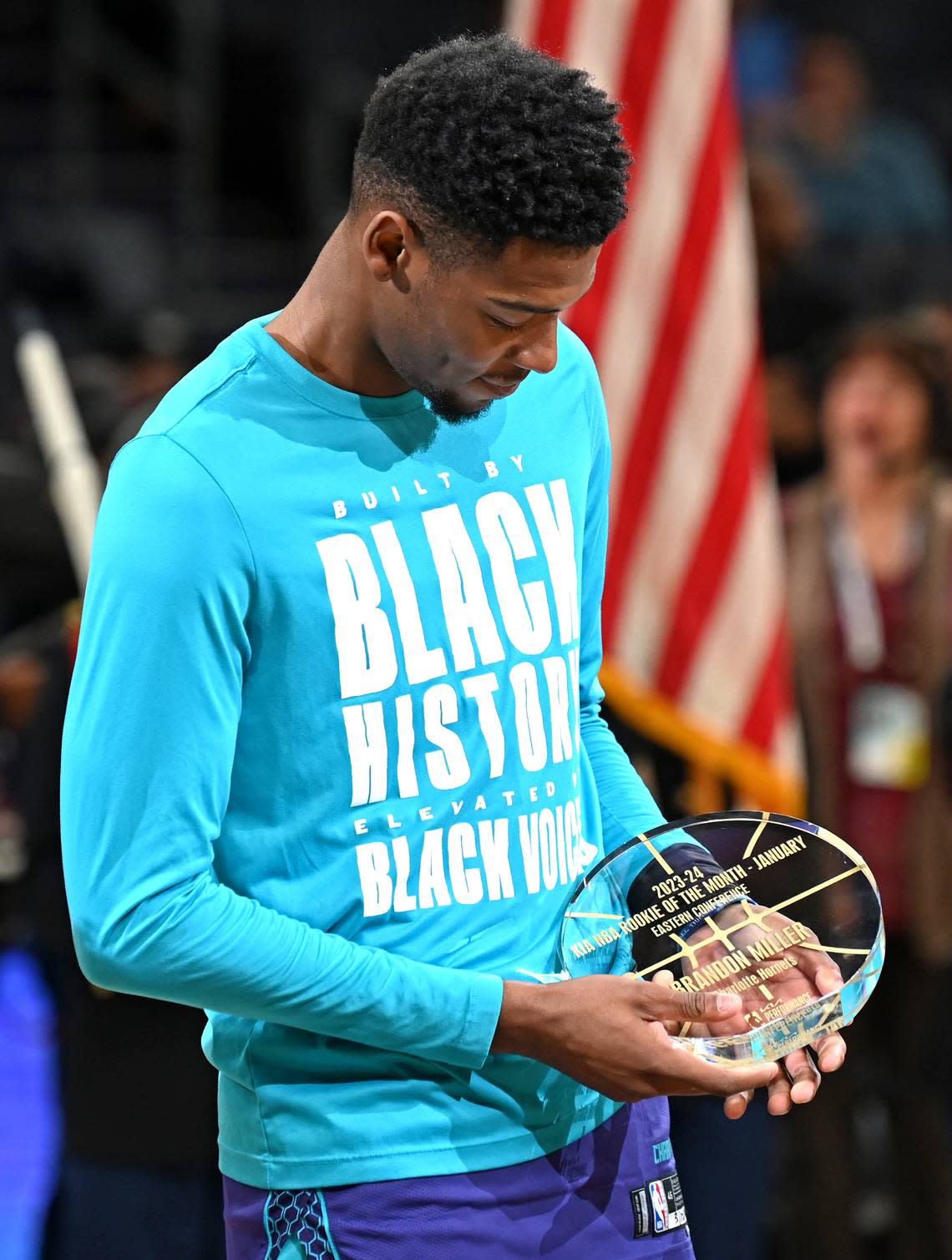 Charlotte Hornets rookie forward/guard Brandon Miller glances down at his KIA NBA Rookie of the Month for January award during a pregame ceremony at Spectrum Center in Charlotte, NC on Monday, February 12, 2024.